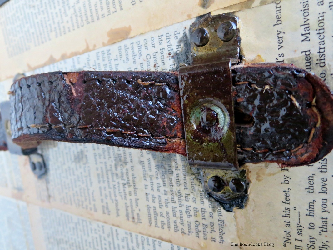 Detail of Old Trunk Covered in Book pages leather handle, The chivalrous Trunk www.theboondocksblog.com