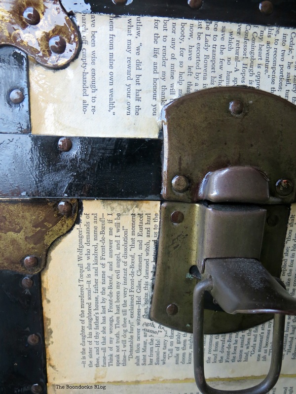 Detail of old trunk covered in Book pages hardware The chivalrous Trunk www.theboondocksblog.com