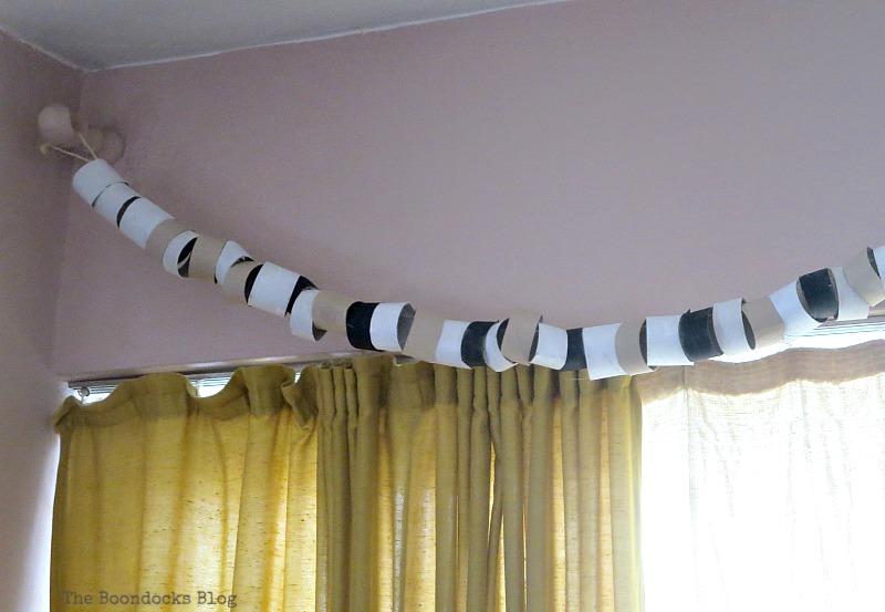 A garland made with paper rolls hanging from brackets, My Irrational Obsession with Paper Rolls www.theboondocksblog.com