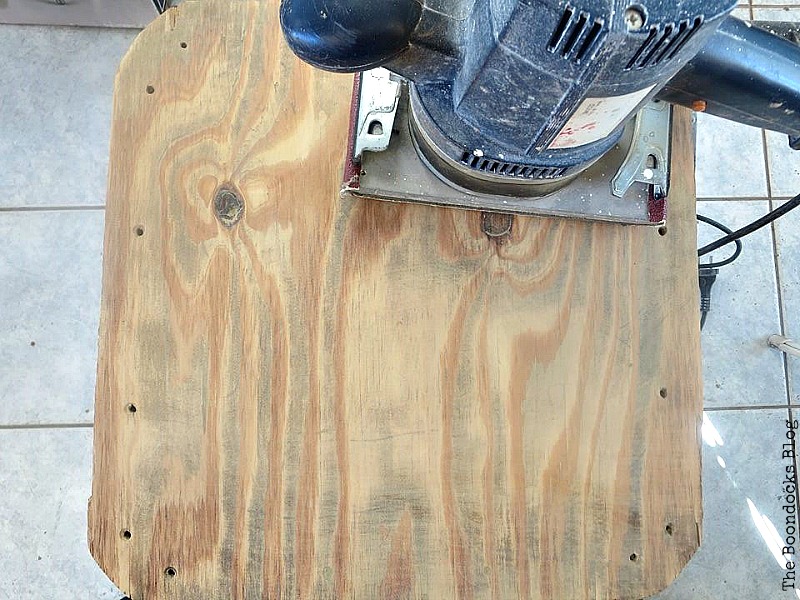 Sanding the plywood top of the table.