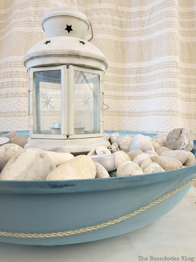 Lantern on top of pebbles with tealights in a grill cover, How to make a Nautical Lantern from a Grill - Int'l Bloggers Club Challenge www.theboondocksblog.com