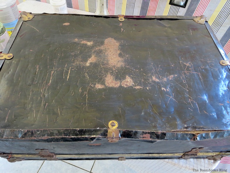 top of a rusted vintage suitcase, used as the "before" image.