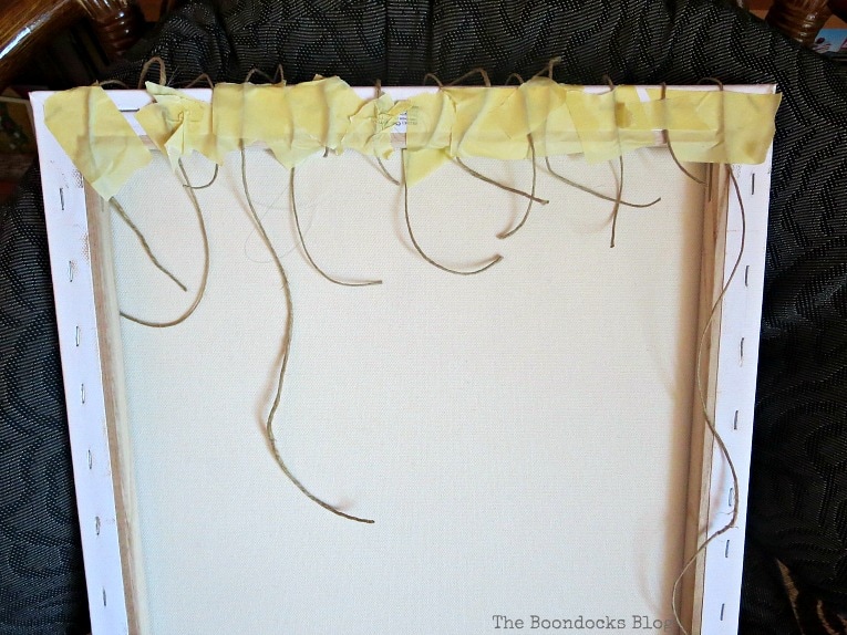 twine taped to the back of canvas with masking tape, How to Make Simple Canvas Wall Art with Keys, www.theboondocksblog.com