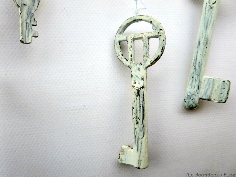 A really cool chalky painted key, How to Make Simple Canvas Wall Art with Keys, www.theboondocksblog.com