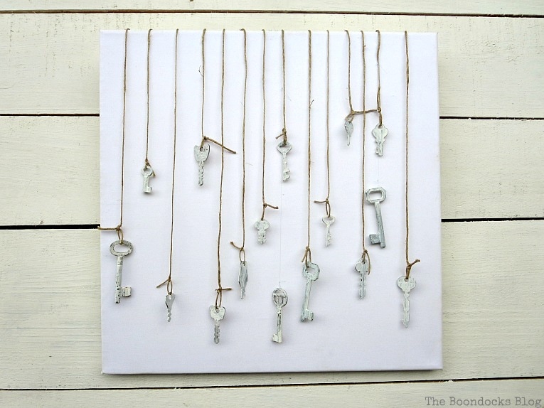 Canvas with keys hanging in front, How to Make Simple Canvas Wall Art with Keys, www.theboondocksblog.com