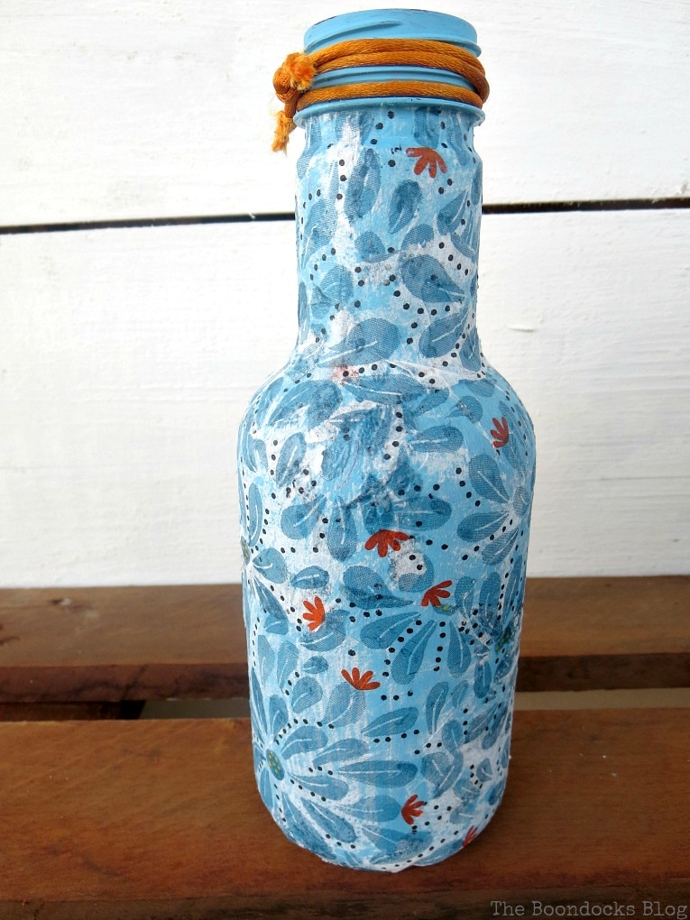 Blue decoupaged bottle.