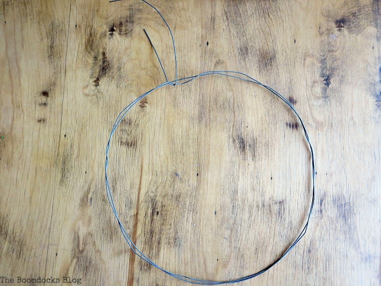 wire shaped into a circle, How To make May Day Wreaths with Recycled Materials www.theboondocksblog.com