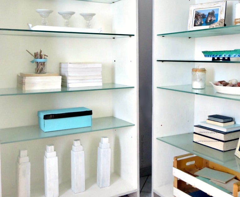 Styled bookcases with blue and white accessories Beachy Nautical style.