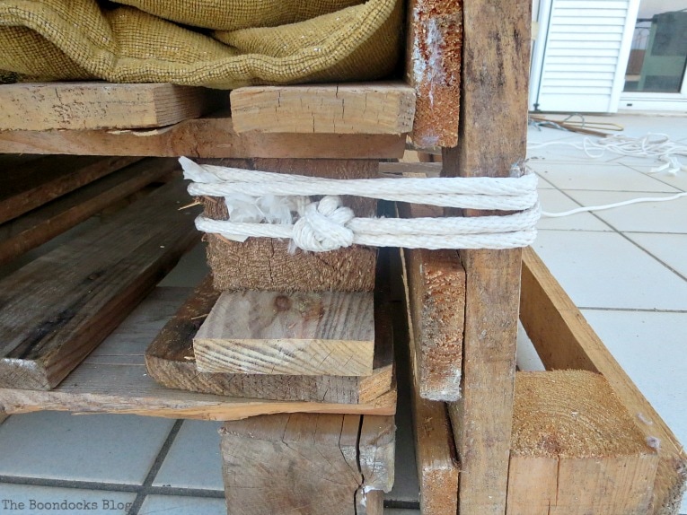 tying the pallets together with rope, Quickly Make a Super Easy Pallet Couch www.theboondocksblog.com