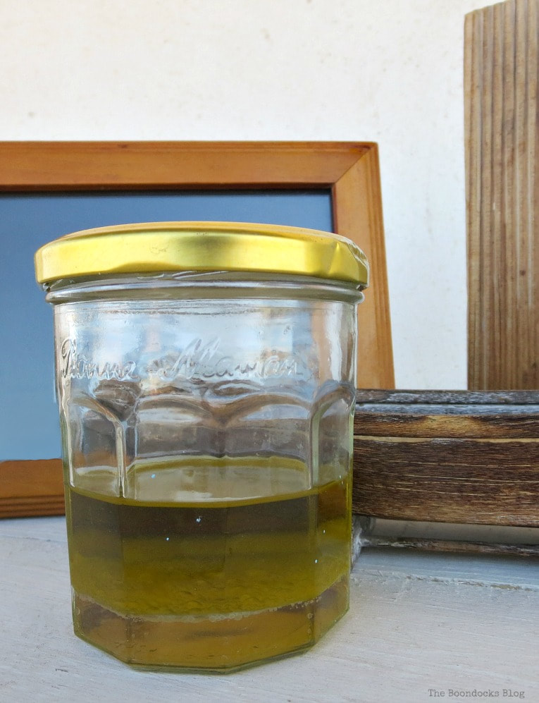 Oil and vinegar mixture in a jar, How to Easily Clean Wood with Just 2 Ingredients www.theboondocksblog.com