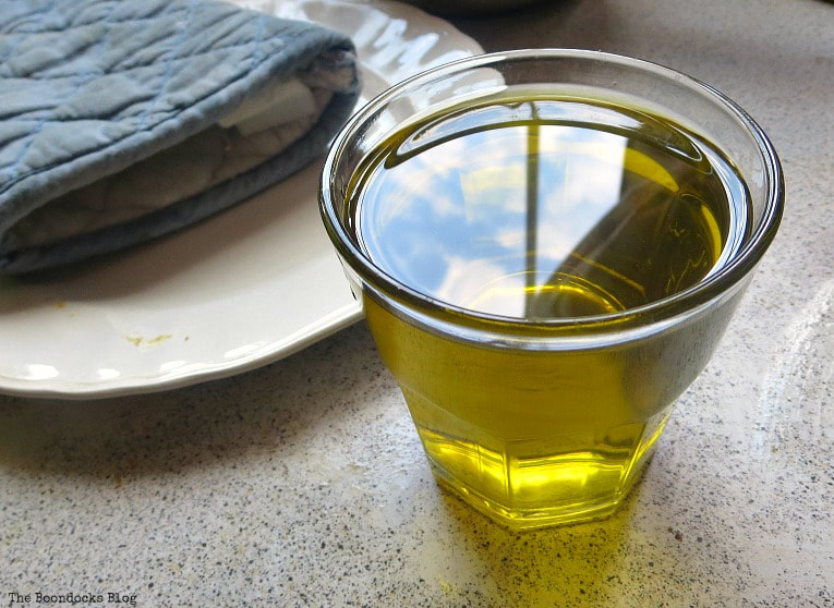 Olive oil in a glass cup.