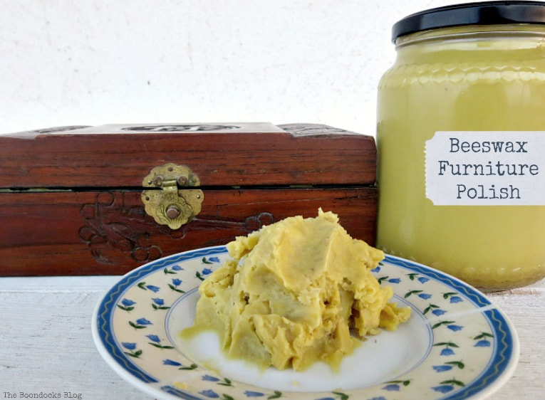 Wood box, beeswax furniture polish in a jar and on a plate.