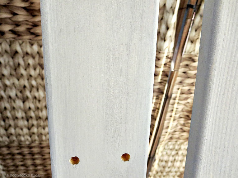 Painted wood with streaks of white paint.