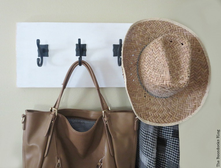 bag, scarf and hat hanging from wood wall hanger, How to Make a Wooden Wall Hanger www.theboondocksblog.com