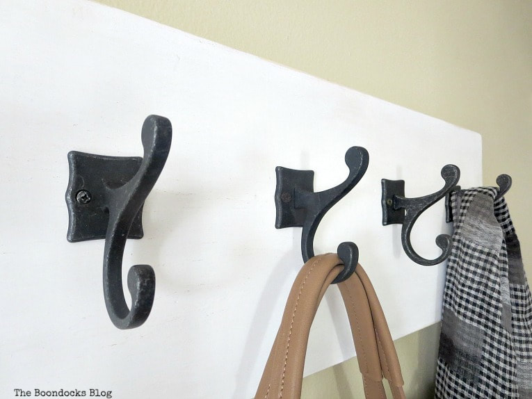 4 metal hooks with a scarf and bag, How to Make a Wooden Wall Hanger www.theboondocksblog.com