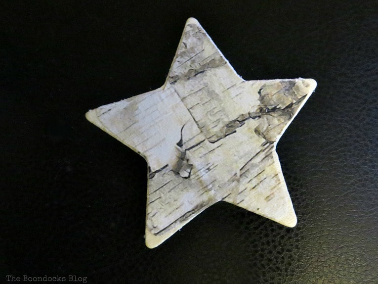 Birch paper decoupaged onto star shape, How to Make Rustic Star Christmas Ornaments www.theboondocksblog.com