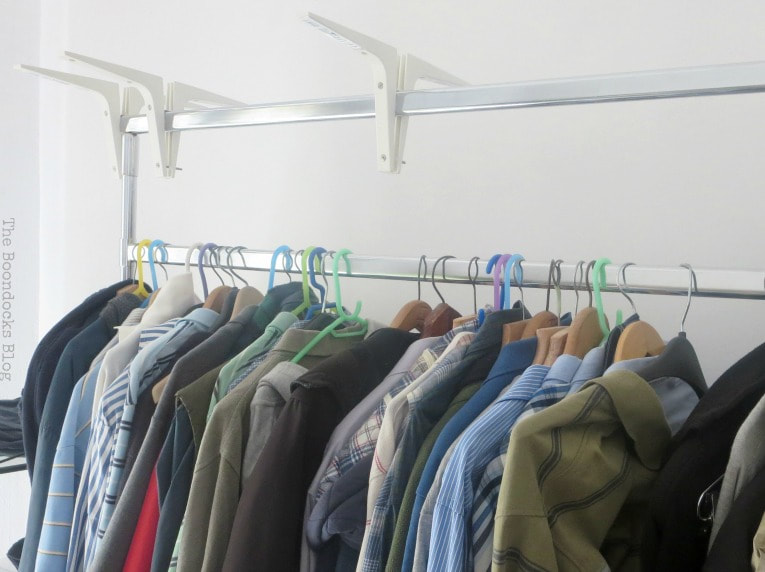 A clothing rack with hangers and clothes.