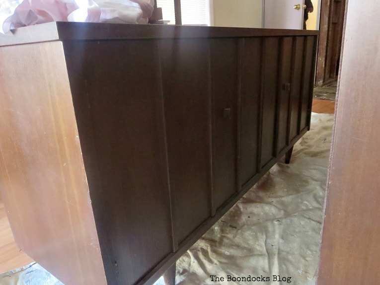 Adding tung oil to the bottom part of the china cabinet.