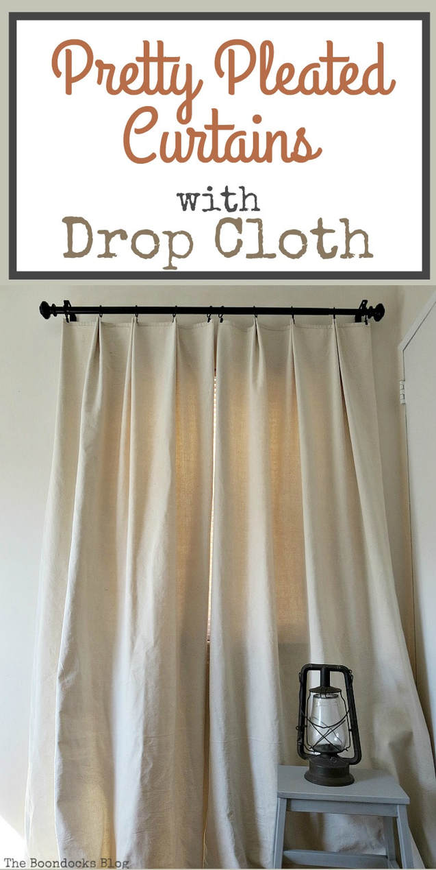 Finished handmade drop cloth curtains mounted on a black rod.