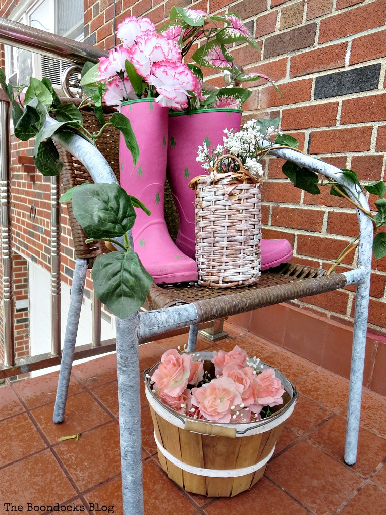 A torn rattan chair repurposed as a display stand for derative items on a front patio.