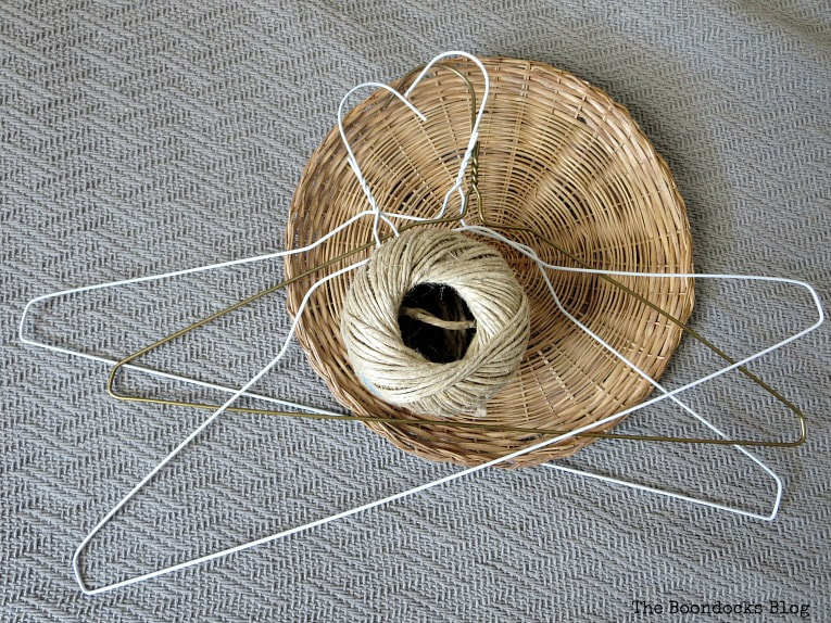 3 hangers, twine and a wicker plate charger.