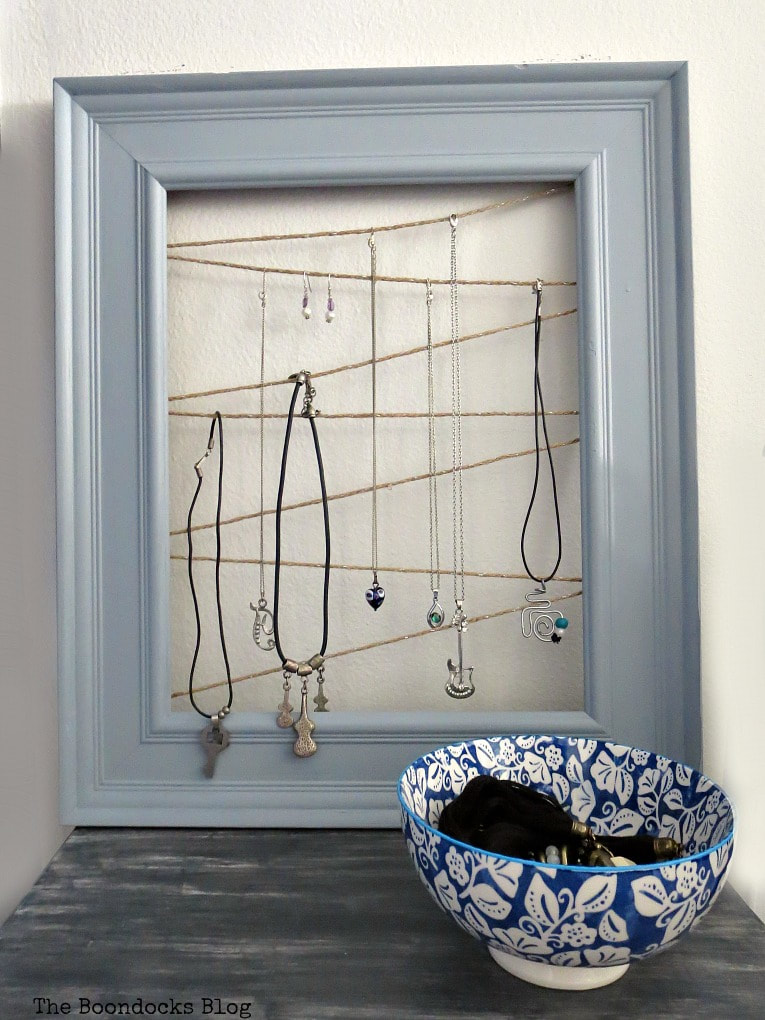 Jewelry organizer made with frame and twine, #Jewelryorganizer #repurpose #organize #frame #easyJewelryorganizer #DIYproject How to Make an Easy Frame Jewelry Organizer www.theboondocksblog.com
