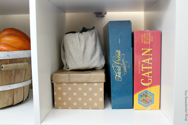 Shoe box covered in gift wrap paper next to board games.