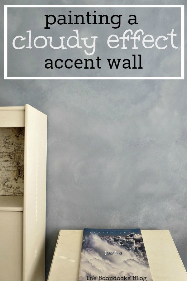 Accent wall with a cloud effect with text overlay "painting a cloudy effect accent wall."