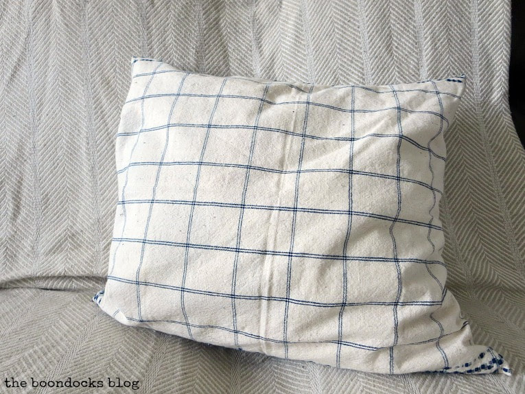 Finished pillow with blue and white check on the other side, How to Make Easy Pillows out of Fabric Remnants 5 ways www.theboondocksblog.com