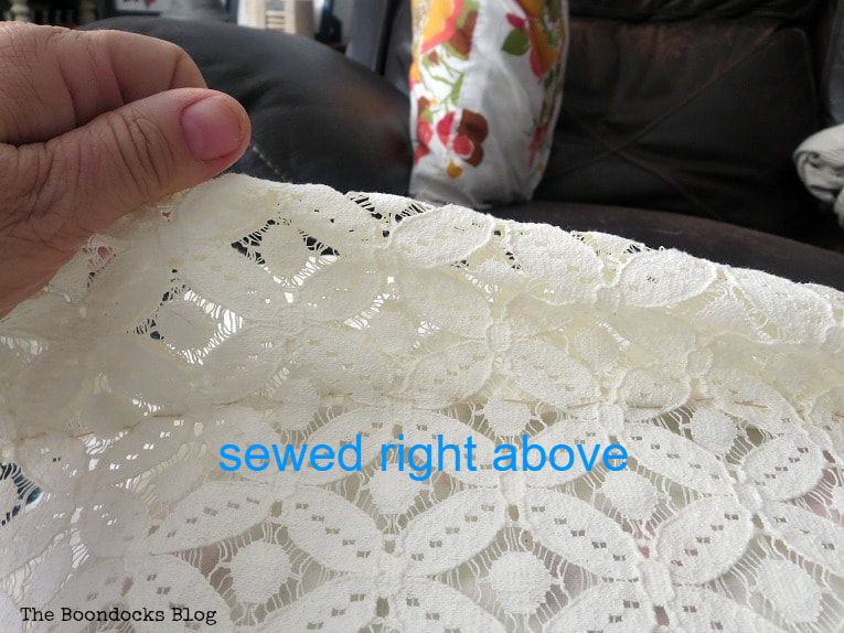Holding up the lace on the lace pillow cover, How to Make Easy Pillows out of Fabric Remnants 5 ways www.theboondocksblog.com