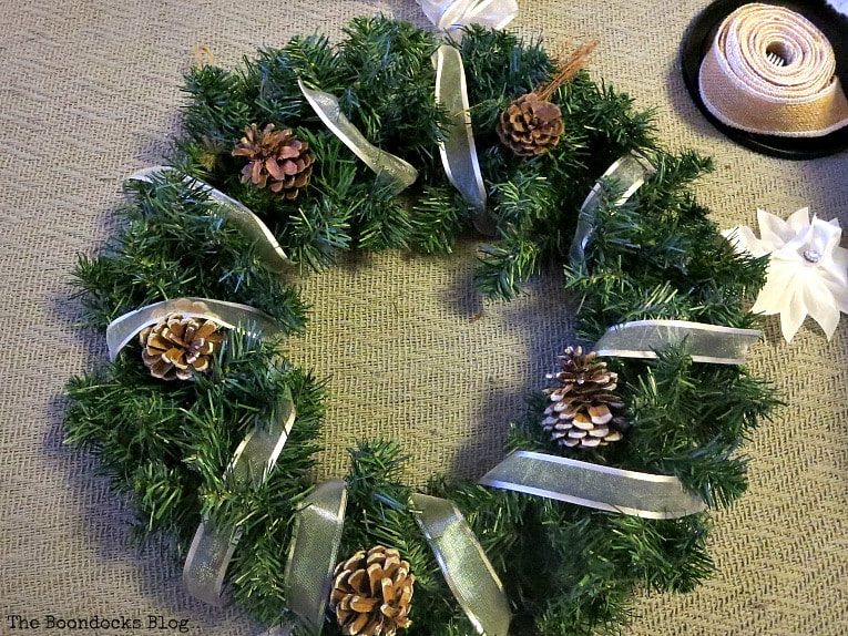 adding the ribbon to wreath, How to Make a Christmas Wreath with Metallic Accents, www.theboondocksblog.com
