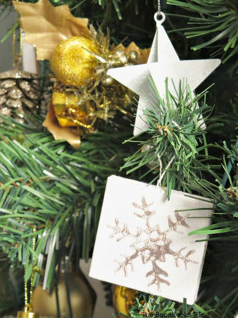 mini canvas with snowflake design on Christmas tree, #christmasornaments #christmascrafts #snowflakeornaments #minicanvas #easycrafts #easychristmascrafts #simplecrafts How to Make Easy Snowflake Mini Canvas Ornaments www.theboondocksblog.com