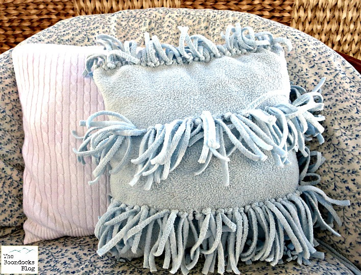 Fleece fabric pillow with fringe.