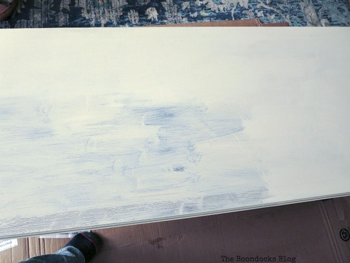 Top of the vintage coffee table after painting it with a coat of beige paint.