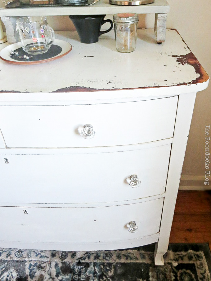 white distressed vintage dresser with glass knobs, #dresser #vintagefurniture #glassknobs #distressedfurniture #bling #shinyknobs How to Make your Dresser Sparkle with Age www.theboondocksblog.com